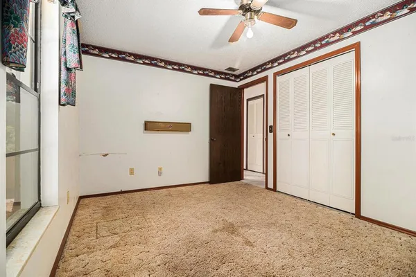 a view of room with a ceiling fan