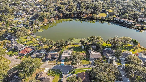 an aerial view of a houses with a lake view