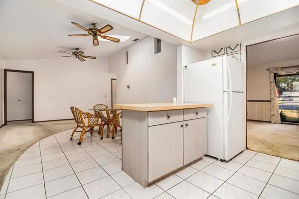 a kitchen with stainless steel appliances a refrigerator and a stove top oven