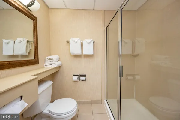 a white toilet sitting next to a bath tub