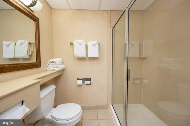 a white toilet sitting next to a bath tub