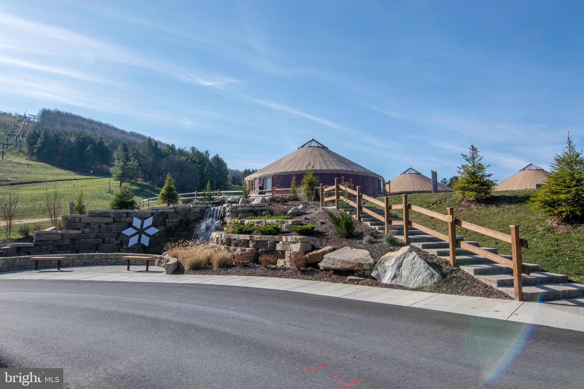290 Marsh Hill Road, Unit 319C McHenry, MD 21541 - Photo 19 of 33 a picture of a building with a bench and trees in the background