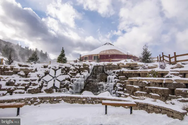 a view of a house with yard and sitting area