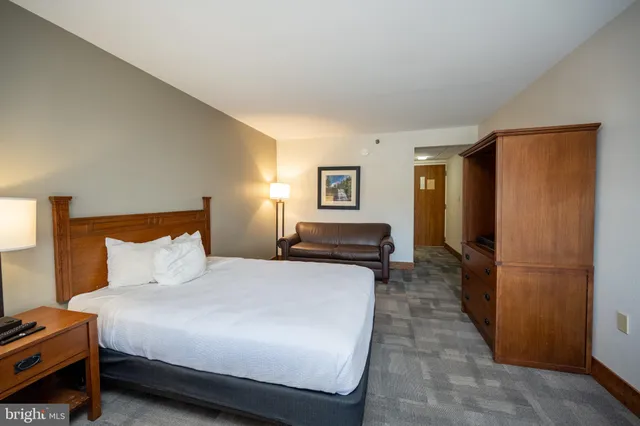 a bedroom with a bed and a couch