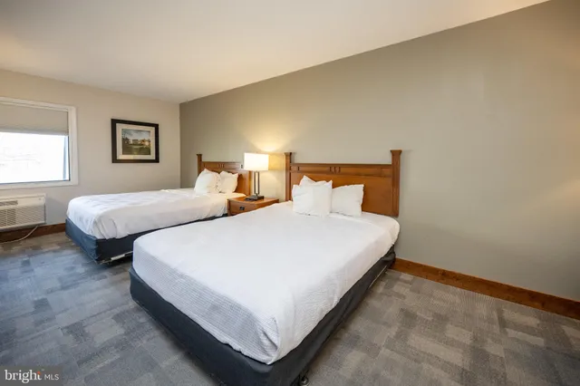 a bedroom with bed and a window