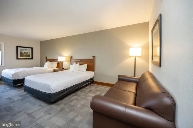 a bedroom with a bed and lamp