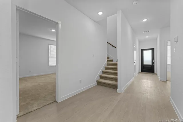 an entryway in a hall with white walls