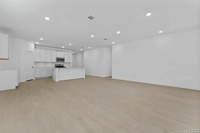 a view of a kitchen with stainless steel appliances