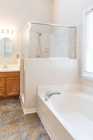 a bathroom with a bathtub and a sink