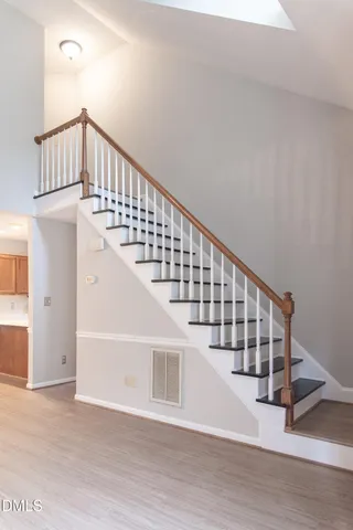 a view of staircase with white walls and a window