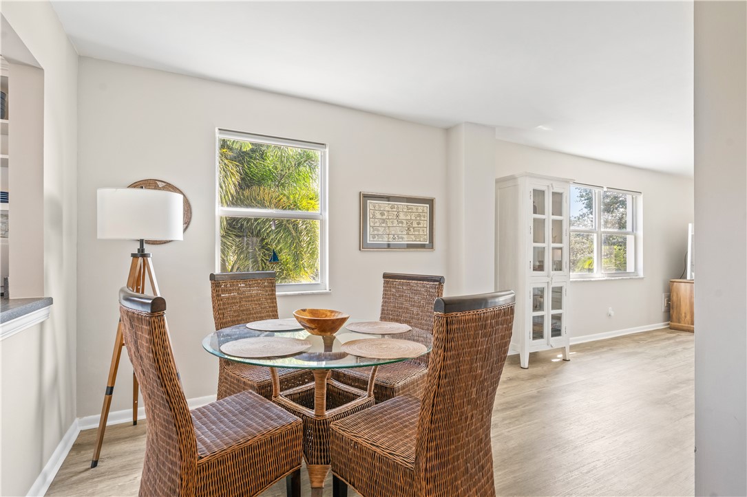 275 Date Palm Road, Unit 307 Vero Beach, FL 32963 - Photo 12 of 36 a view of a dining room with furniture window and wooden floor
