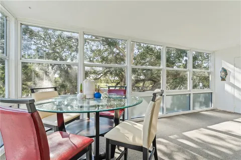 a dining room with furniture window and outside view