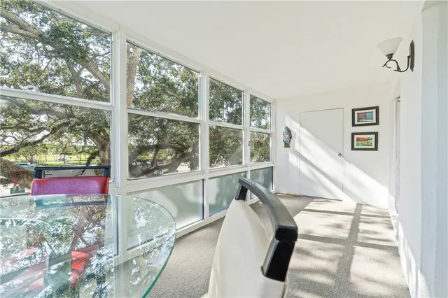 a view of a room with wooden floor and windows