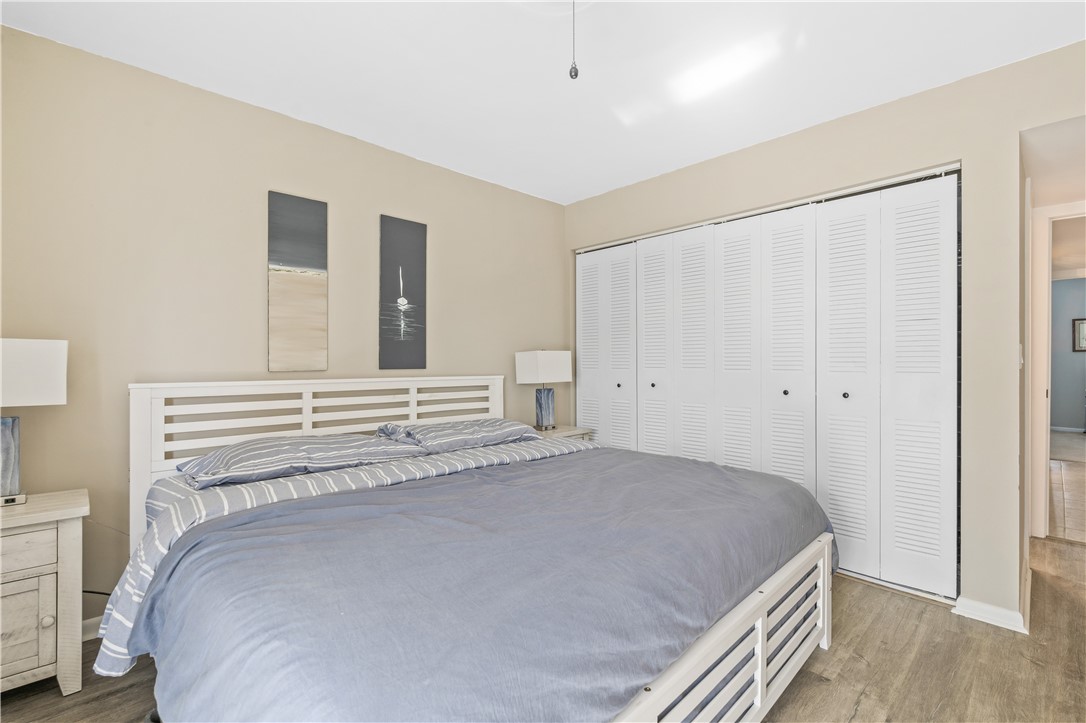 275 Date Palm Road, Unit 307 Vero Beach, FL 32963 - Photo 19 of 36 a bedroom with a bed and a cabinets