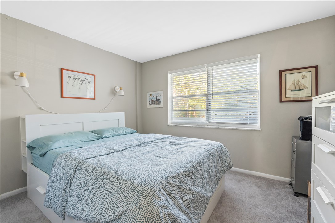 275 Date Palm Road, Unit 307 Vero Beach, FL 32963 - Photo 21 of 36 a bedroom with a bed and a window