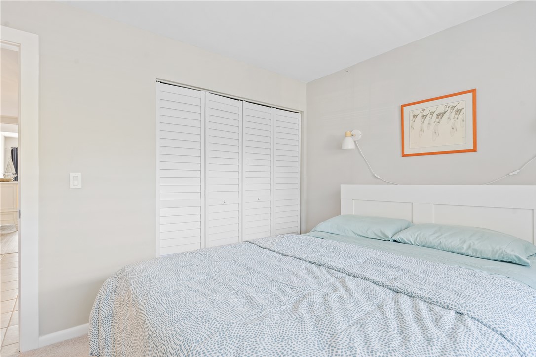 275 Date Palm Road, Unit 307 Vero Beach, FL 32963 - Photo 22 of 36 a bedroom with a bed and a wall painting