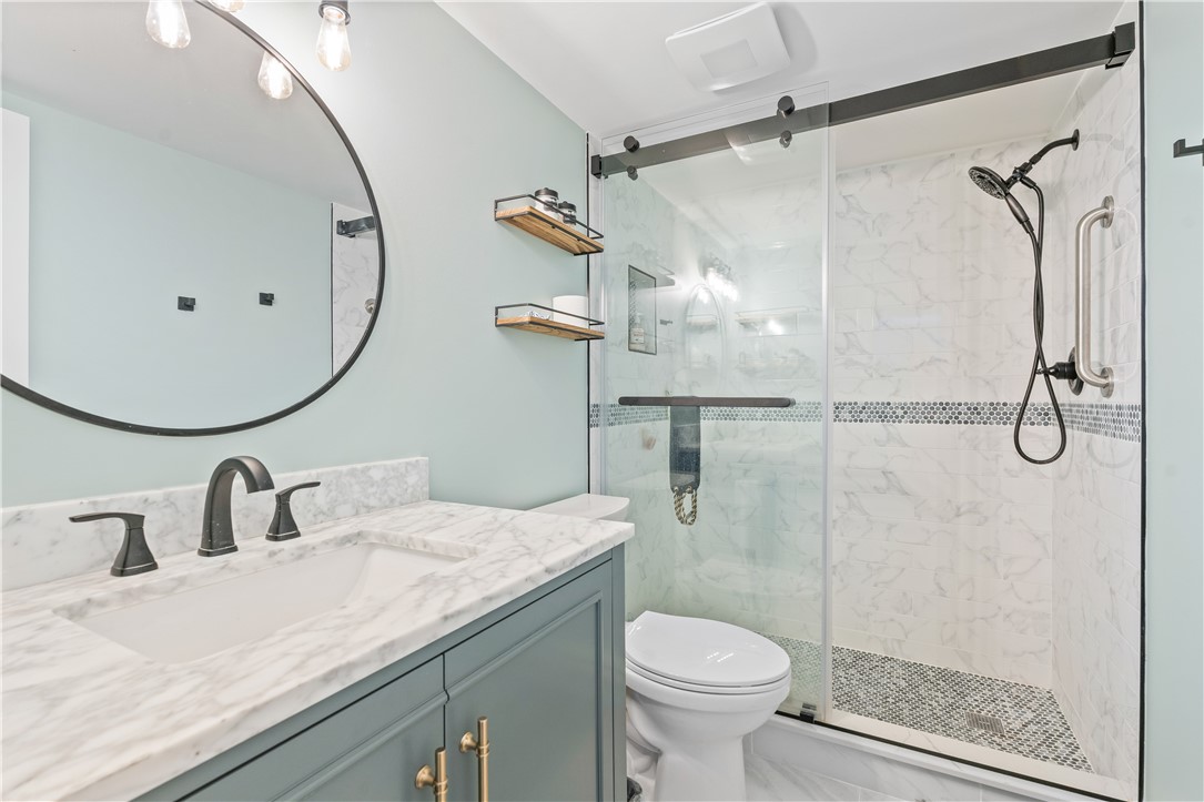 275 Date Palm Road, Unit 307 Vero Beach, FL 32963 - Photo 4 of 36 a bathroom with a granite countertop sink toilet and shower
