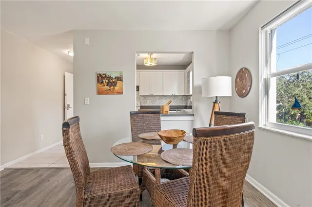 a living room with furniture a window and kitchen view