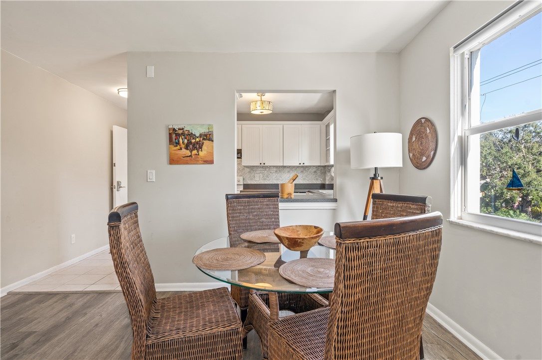 275 Date Palm Road, Unit 307 Vero Beach, FL 32963 - Photo 9 of 36 a living room with furniture a window and kitchen view