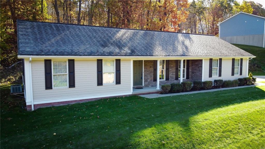 a view of house with backyard