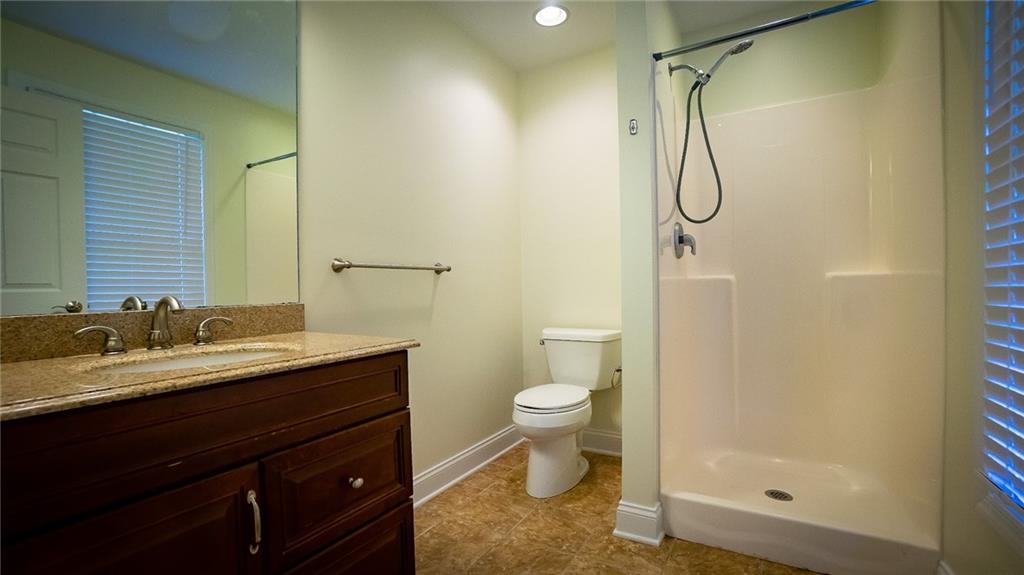 221 Old Plank Road Butler, PA 16002 - Photo 19 of 25 a bathroom with a granite countertop sink toilet and shower