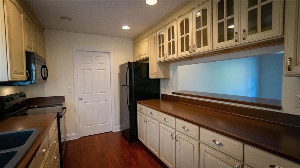 221 Old Plank Road Butler, PA 16002 - Photo 6 of 25 a kitchen with stainless steel appliances granite countertop a refrigerator a stove and a sink with wooden floor
