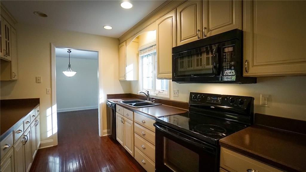 221 Old Plank Road Butler, PA 16002 - Photo 7 of 25 a kitchen with stainless steel appliances granite countertop white cabinets and black stove top oven with granite countertops