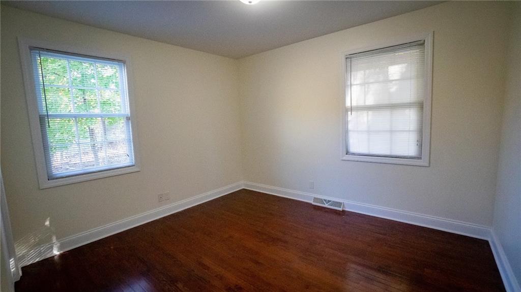221 Old Plank Road Butler, PA 16002 - Photo 9 of 25 an empty room with wooden floor and windows