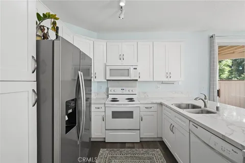 a kitchen with a sink cabinets and refrigerator