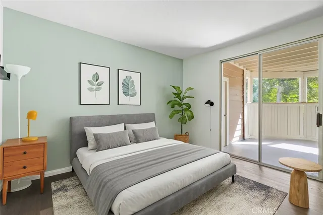 a bedroom with a bed and a painting on the wall