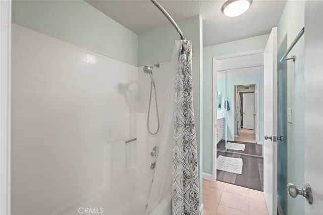 a bathroom with a shower and a sink