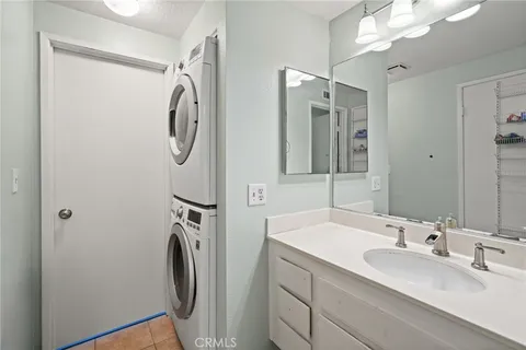 a bathroom with a double vanity sink mirror and shower