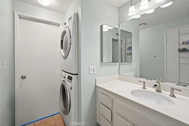 a bathroom with a double vanity sink mirror and shower