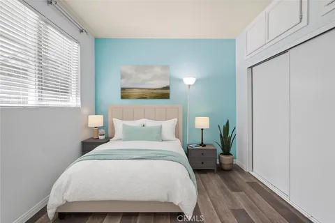 a bedroom with a bed a mirror and a window