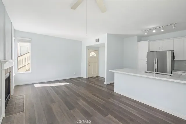 a view of kitchen with wooden floor and electronic appliances