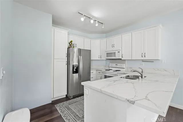 a kitchen with a refrigerator and cabinets