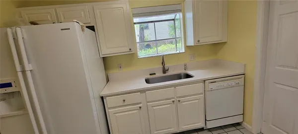 a kitchen with a refrigerator and a sink