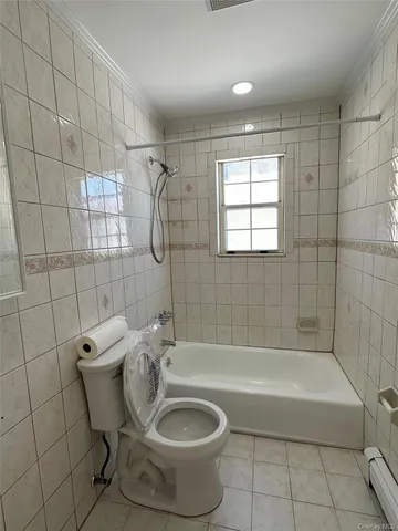 a bathroom with a bathtub and shower