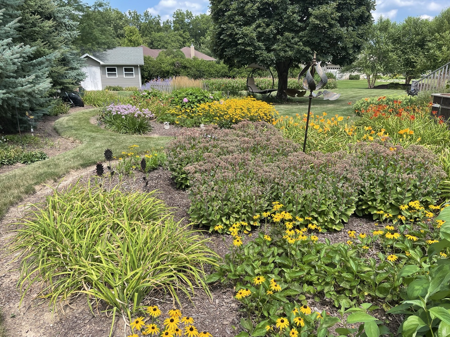 8701 South Rood Road Kingston, IL 60145 - Photo 22 of 26 a view of a garden with a bench