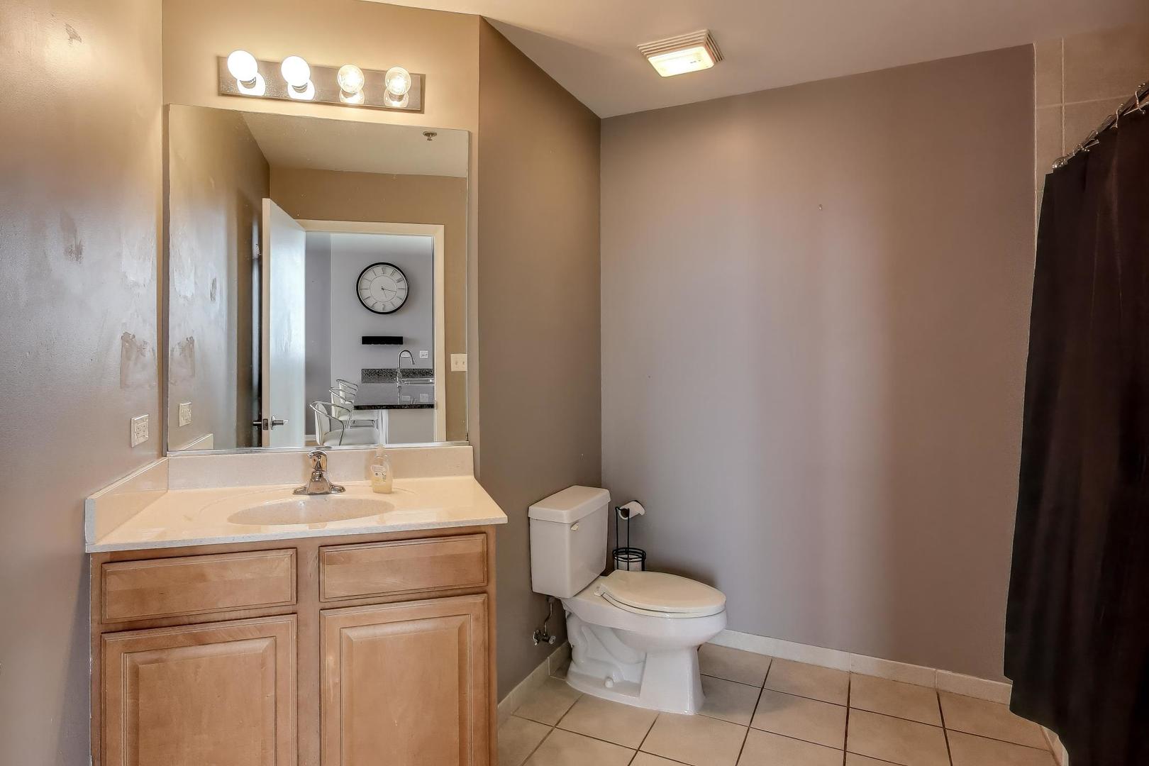 1600 South Indiana Avenue, Unit 1602 Chicago, IL 60616 - Photo 15 of 30 a bathroom with a toilet sink and mirror