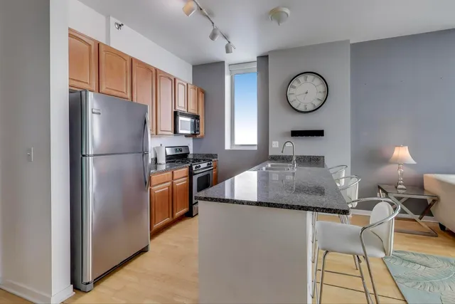 a kitchen with granite countertop a sink and a counter top space