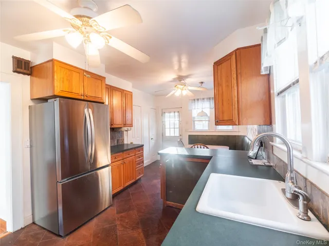 a kitchen with a refrigerator a sink and cabinets