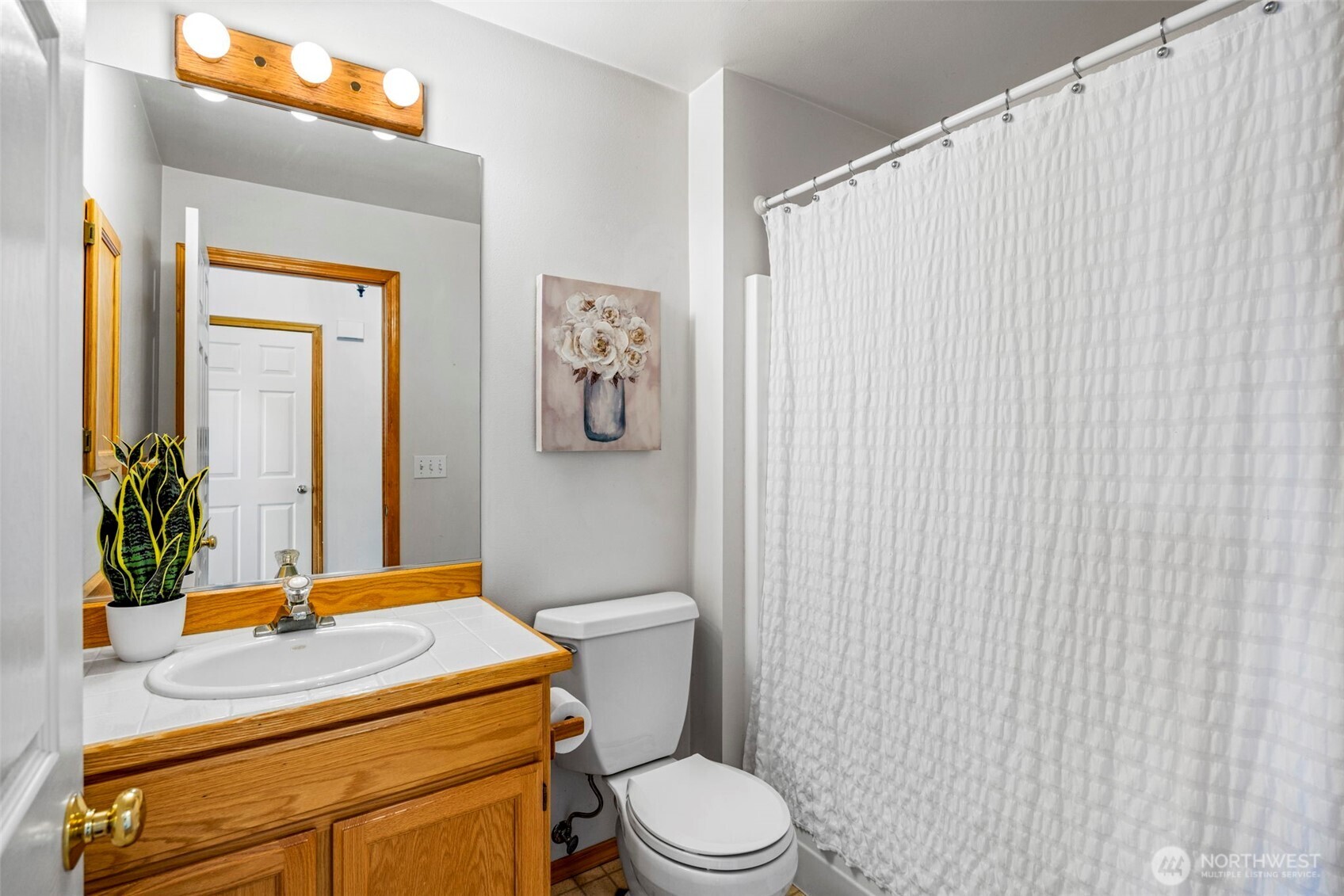 19736 Northwest Stavis Bay Road Seabeck, WA 98380 - Photo 25 of 39 a bathroom with a sink a toilet and shower curtain