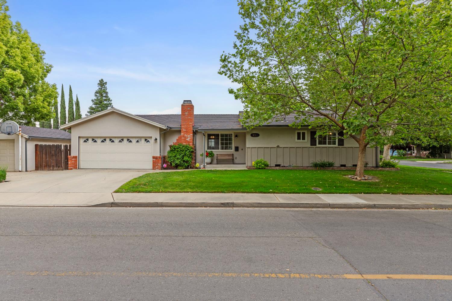 550 Bell Street Turlock, CA 95380 - Photo 2 of 36 a sign board with a small yard and a large parking space