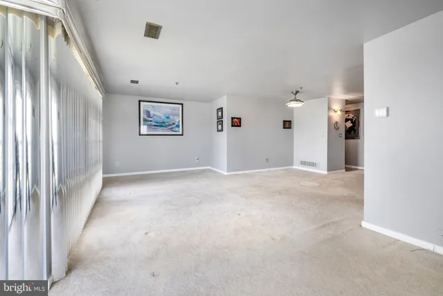 a view of a hallway with wooden floor and entryway