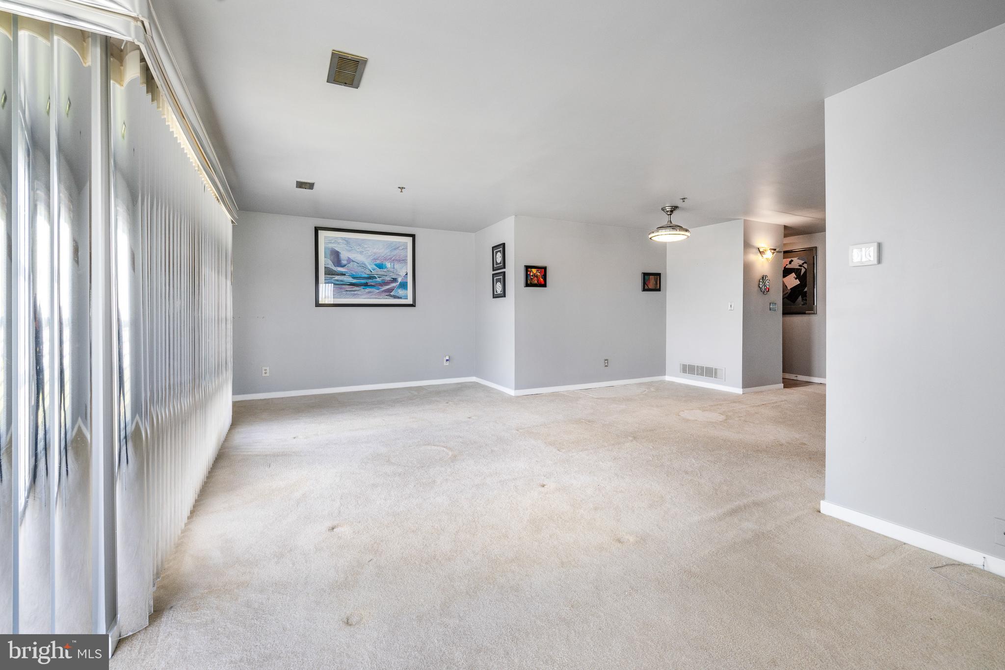 5213 Le Parc Drive, Unit 4 Wilmington, DE 19809 - Photo 12 of 37 an empty room with entrance and windows