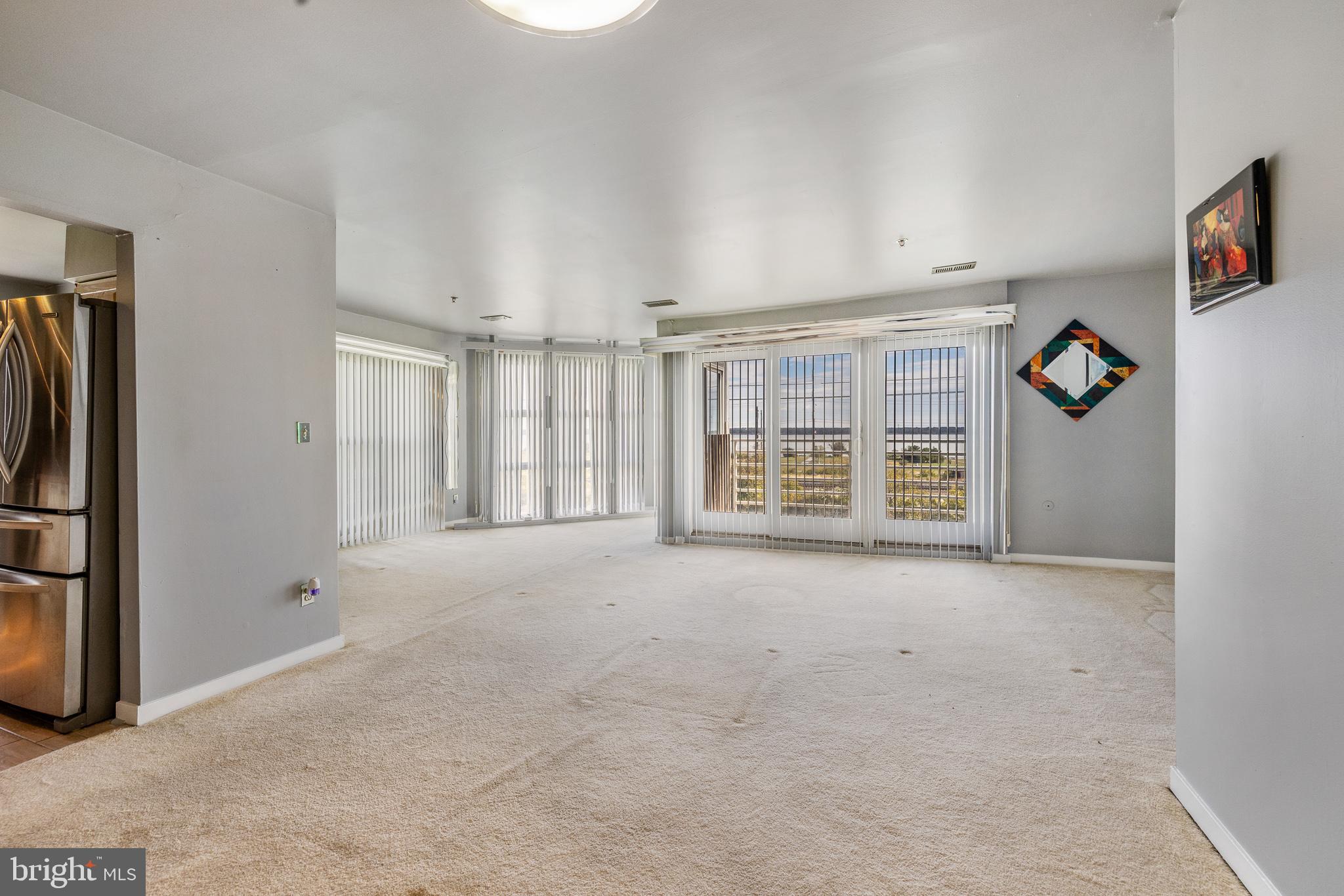 5213 Le Parc Drive, Unit 4 Wilmington, DE 19809 - Photo 14 of 37 an empty room with windows and closet