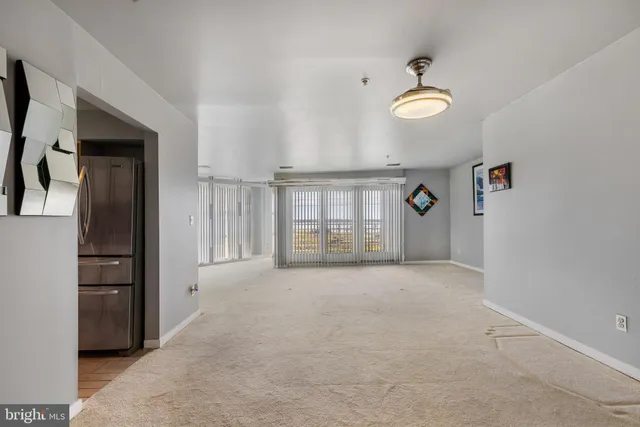 a view of a big room with closet and chandelier fan