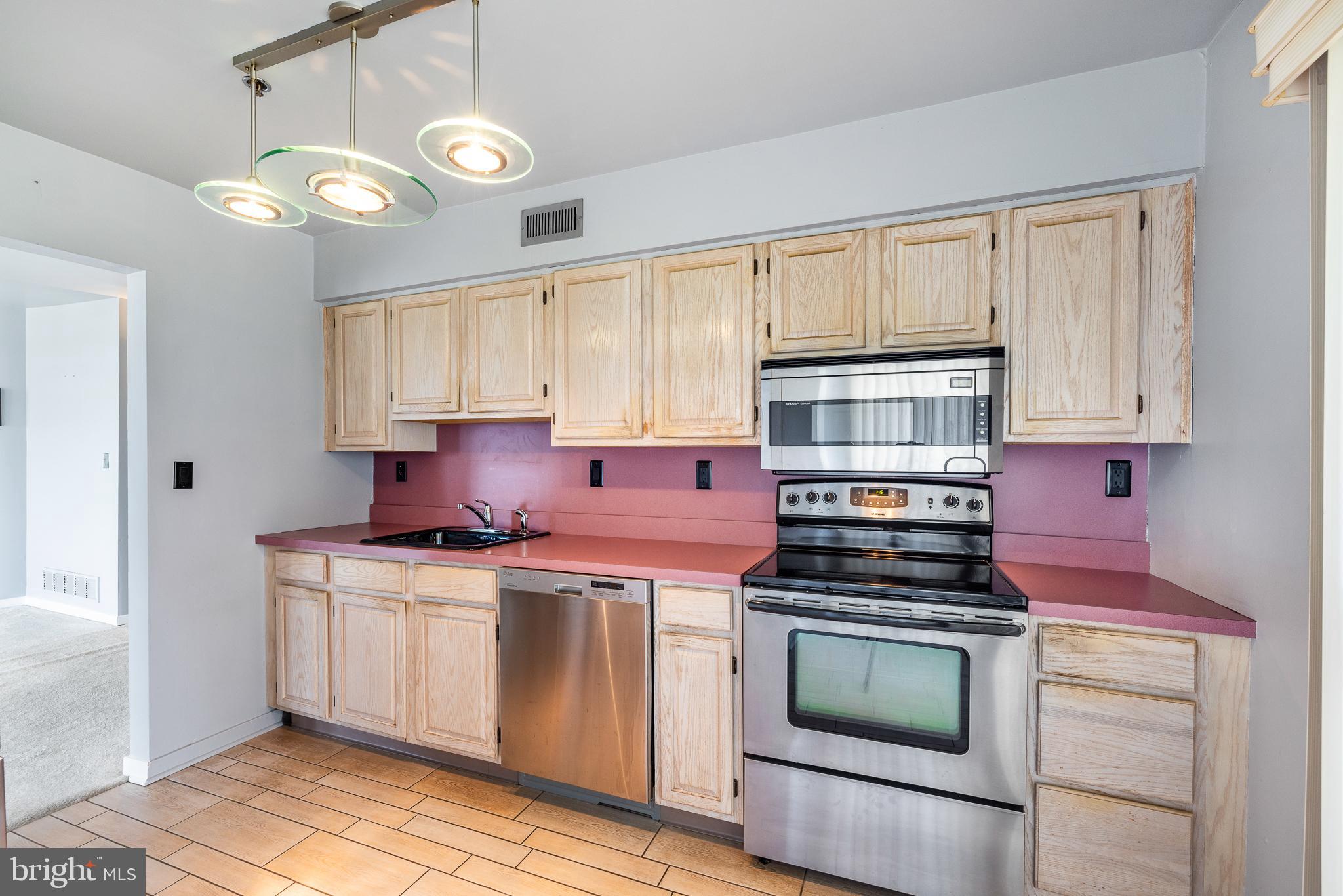 5213 Le Parc Drive, Unit 4 Wilmington, DE 19809 - Photo 23 of 37 a kitchen with cabinets appliances and a window