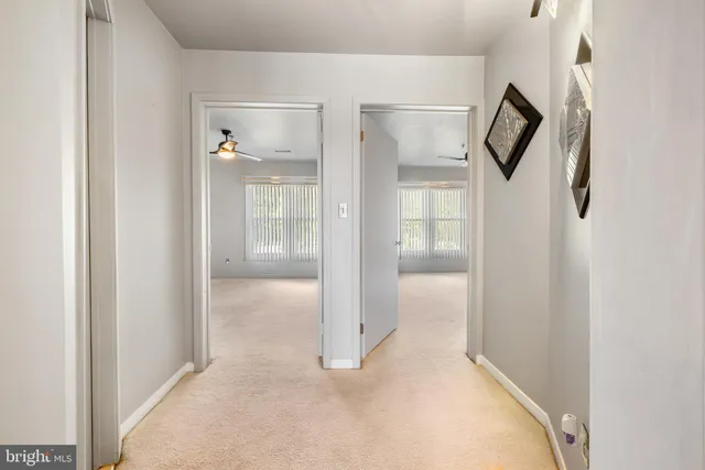 a view of a hallway with wooden shelves